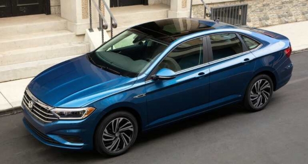 A side view of a Volkswagen Jetta on the road
